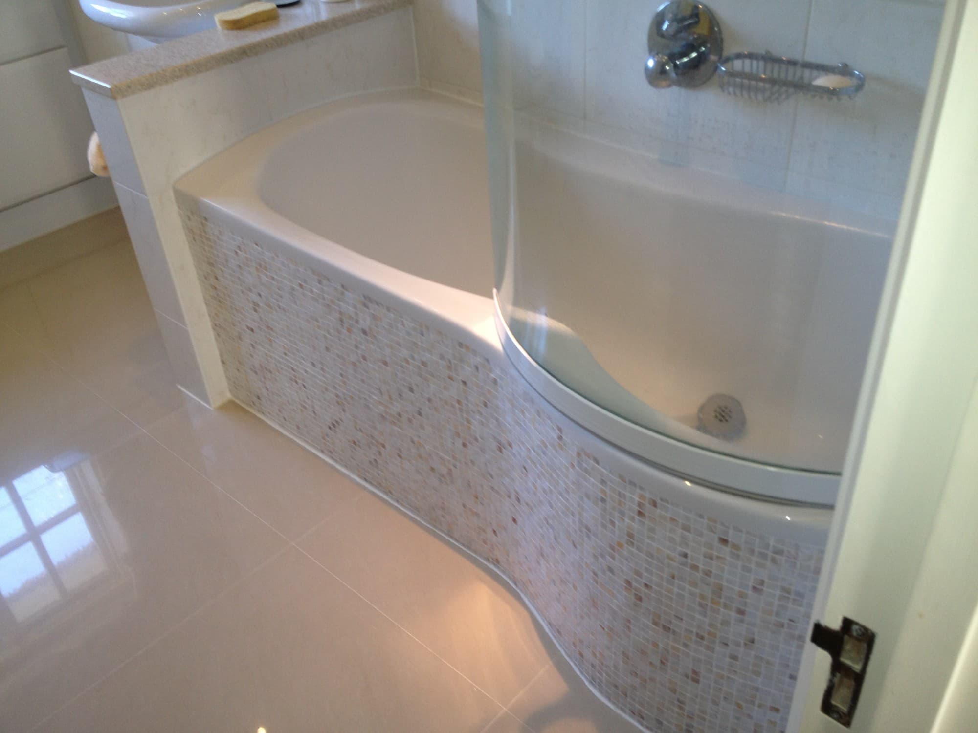Bathroom renovation by The Snagman — mosaic tiled bath panel detail